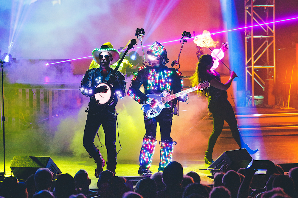 LED-costumed performers with guitars on stage at a Branson variety show