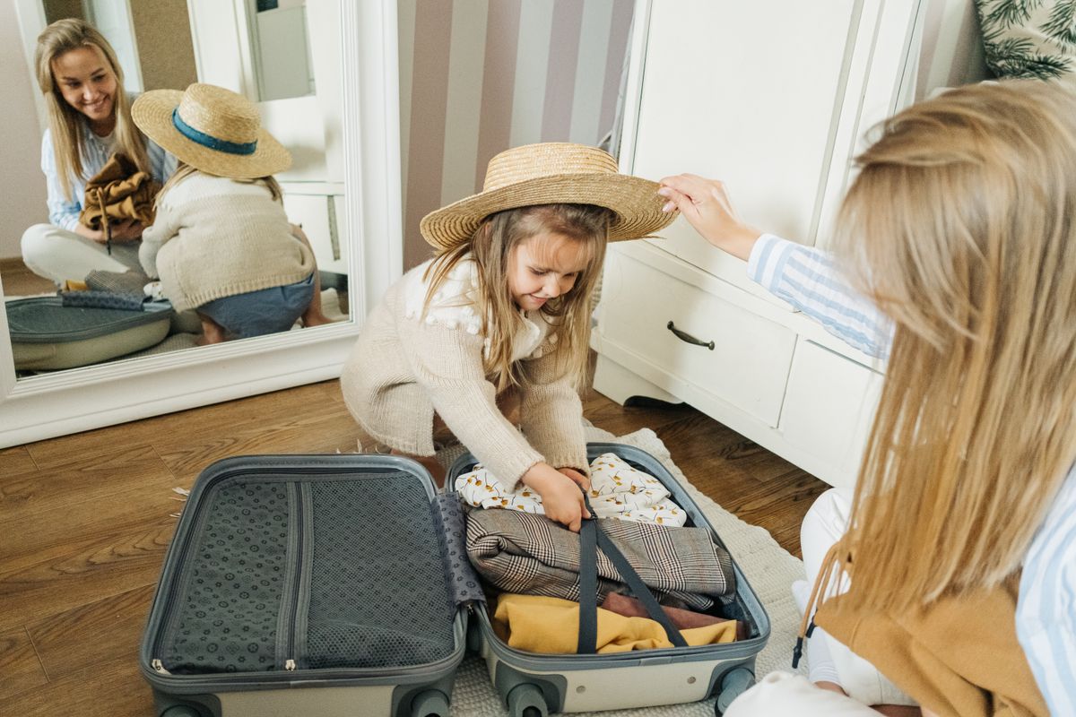 Mother and daughter packing a suitcase at home for a family vacation to Branson